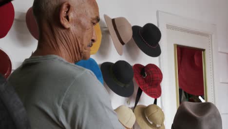 mixed race man working at a hat factory