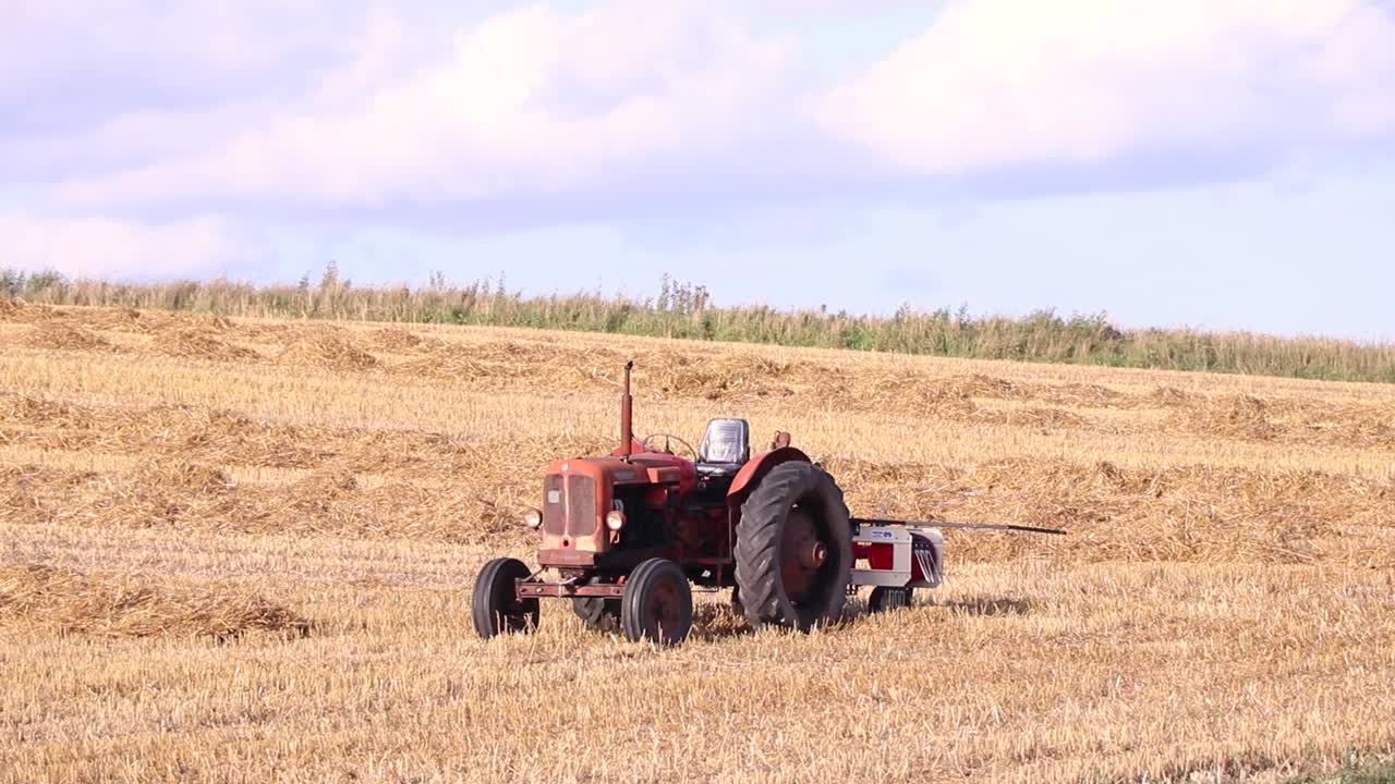 Tractor on open field, summer.