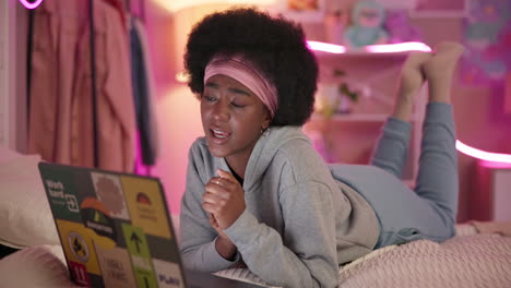 young woman using laptop in bed