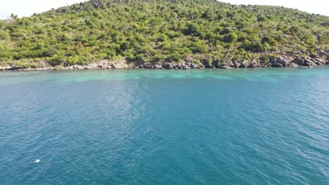 speedy aerial flying past a large catamaran yacht in the british virgin islands