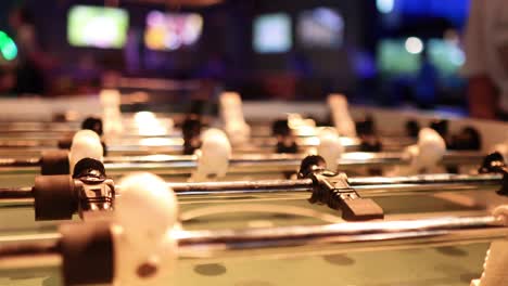 intense foosball match in a lively bar