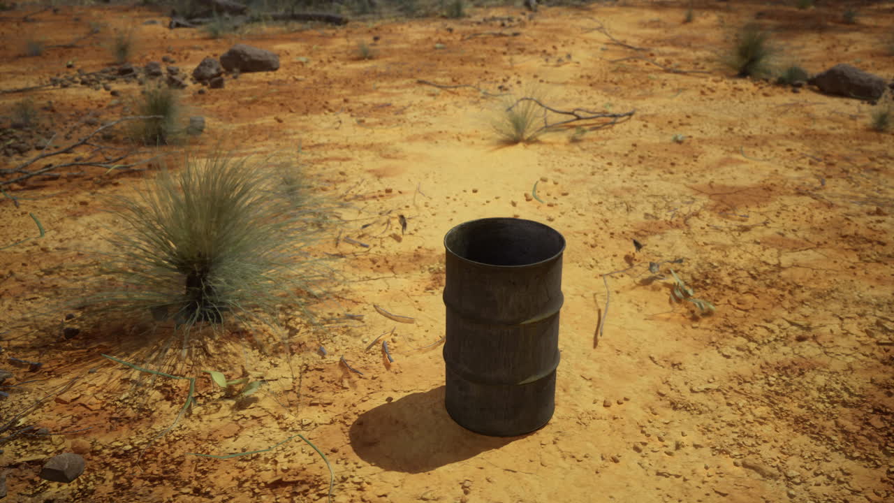 Abandoned metal barrel stands alone in the desolate arid desert landscape