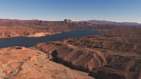 colorado river cutting through red rock hills and mountains