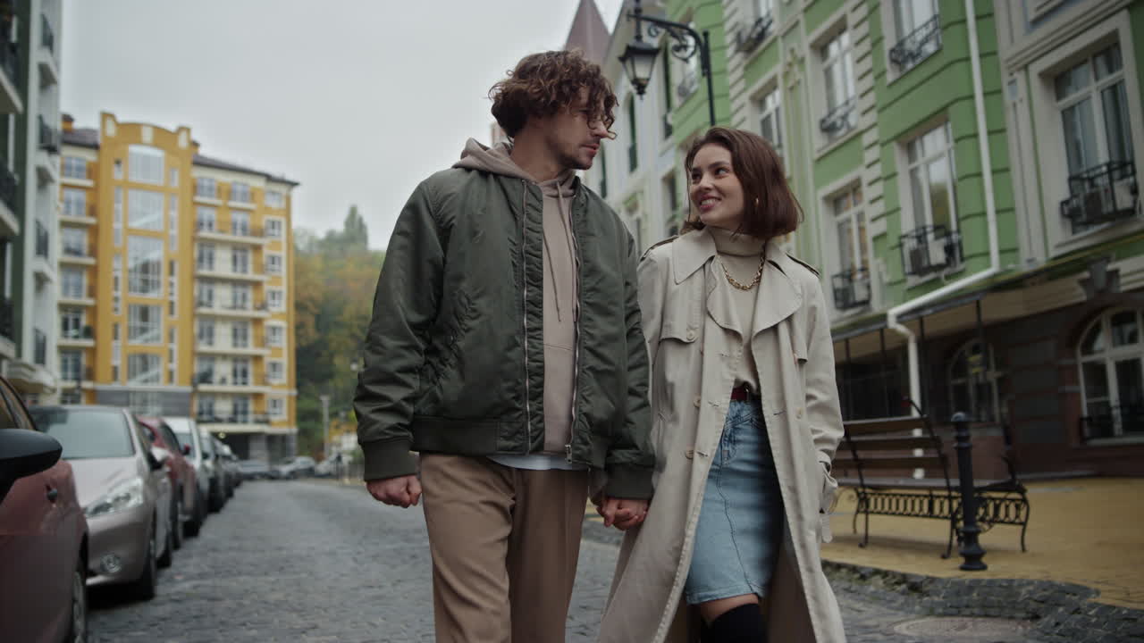 Romantic couple walking on urban street. Man and woman talking together outdoor.
