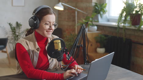 cheerful woman recording podcast in studio