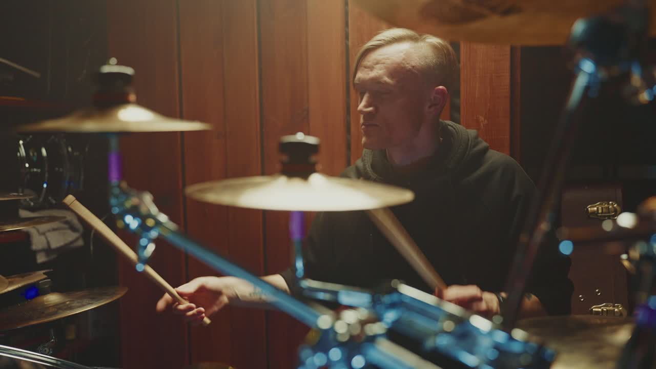 Drummer playing drums in a studio