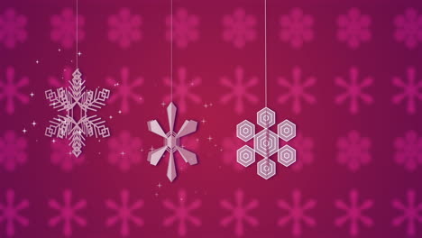 animación de copos de nieve blancos girando sobre un fondo rosado