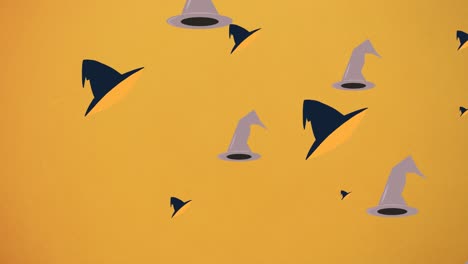 Animation-of-falling-witchs-hats-on-orange-background