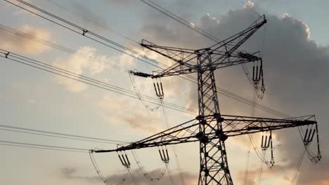 high-voltage power lines at vividly colored sunset