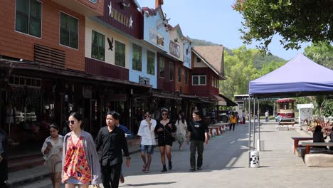 crowded market street with diverse visitors and stalls