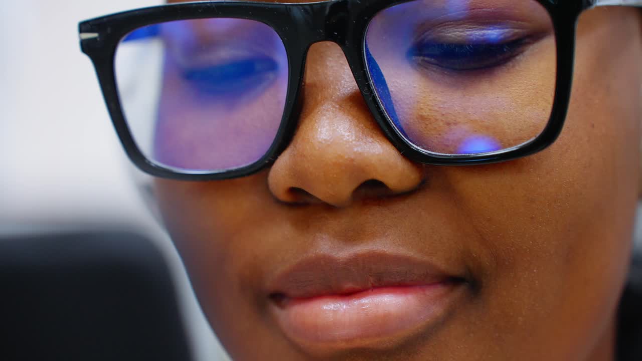 Close-up of a Person Wearing Glasses with Screen Reflection