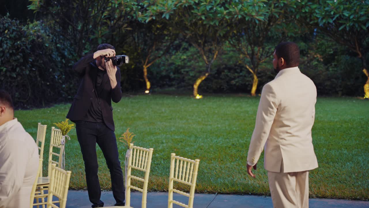 A photographer captures moments at an outdoor wedding event