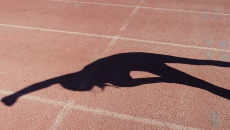 low section of female athlete exercising on race track at sports venue 4k