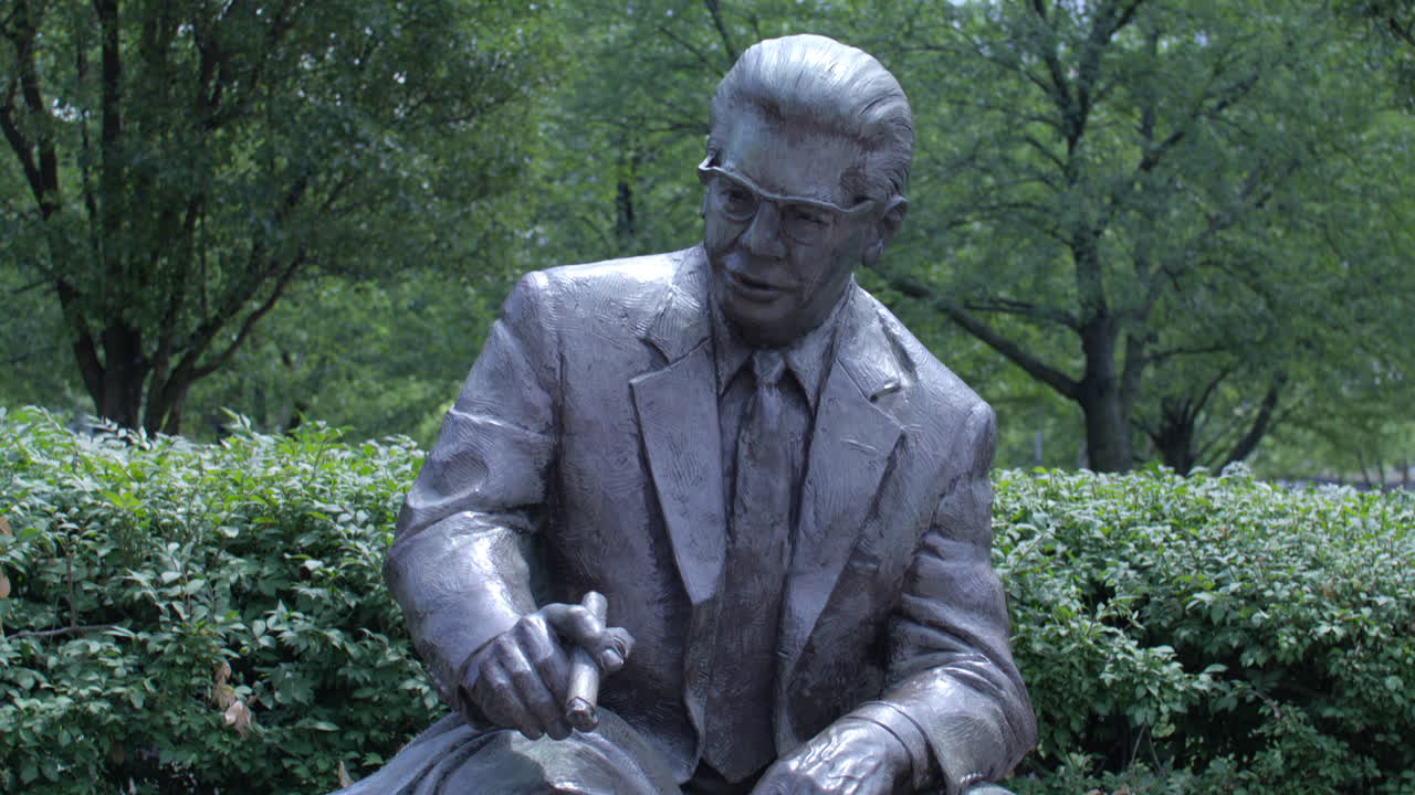 Bronze Statue of a Seated Man in a Park