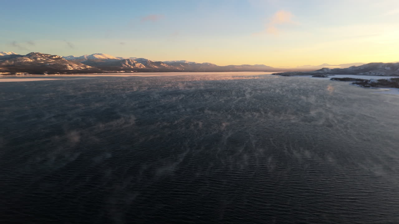 Flying Above Lake Laberge During Sunset Of Winter In Yukon, Canada - Drone Shot