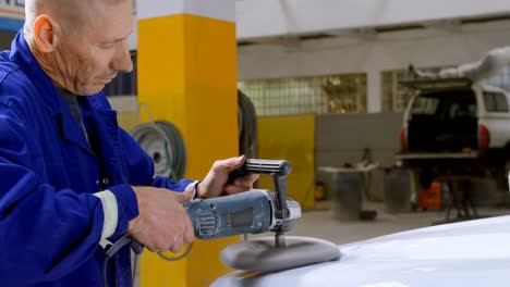 mechanic polishing a car with grinder 4k