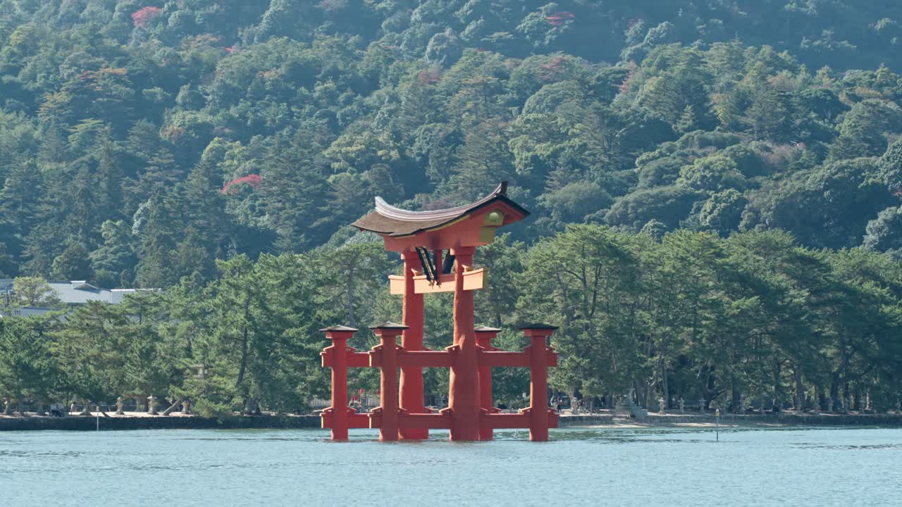 Against a picturesque backdrop, the torii gate of Itsukushima Shrine on Miyajima Island is a stunning display of cultural and spiritual beauty in Hiroshima, Japan.