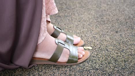 woman wearing sandals and dress outdoors