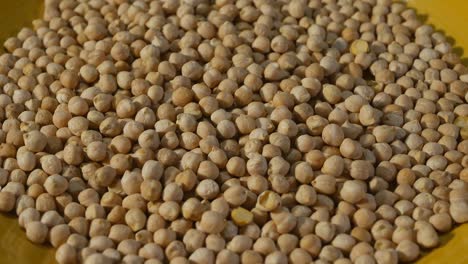 chickpeas in a yellow plate. top view. close-up. rotation. loop video