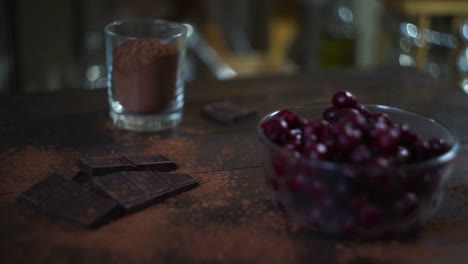 man hand take glass cup with cocoa powder. ingredients for baking cake