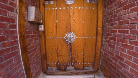 traditional wooden door with metal knocker at bukchon hanok village in seoul, south korea. - tilt down shot