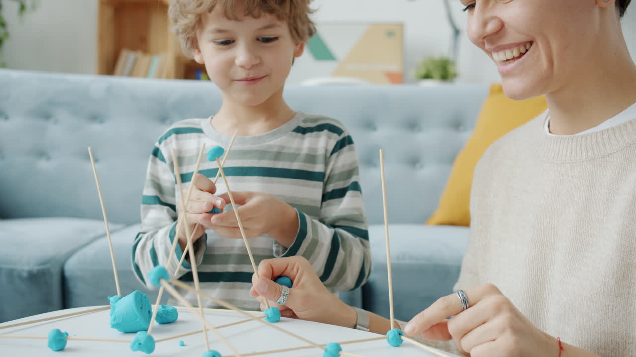 Mother and Child Playing with Clay and Sticks