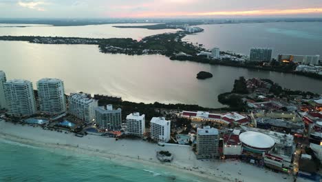 Aerial-of-Riviera-Maya-Cancun-Mexico-hotel-zone-with-luxury-resort-front-water-tropical-white-sand-beach-drone-footage