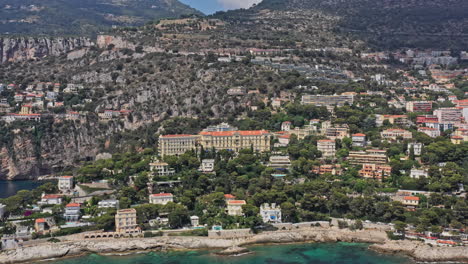 cap d'ail france aerial v3 pan shot overlooking hillside housing estate and holiday resorts in seaside neighborhood with waterfront views - july 2021