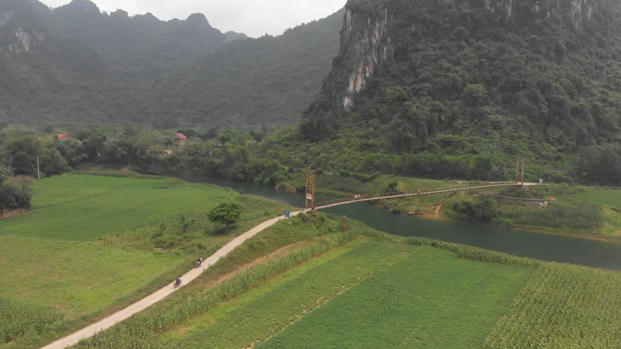 Phong Nha with old suspension bridge over river at Vietnam, aerial