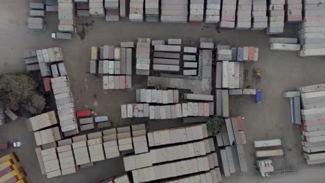 aerial birds eye view of stacked cargo containers at storage site in karachi