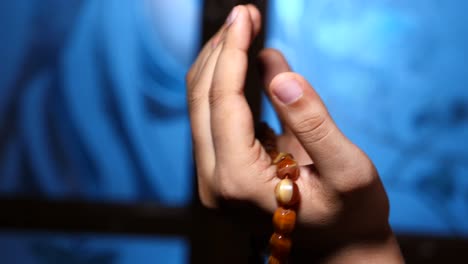 praying hands with rosary