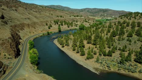 us, oregon, spray, john day river, 2025-05-06 - drone view of the north fork of the john day river in spring time, with a highway and green fields with the desert grasses and hillsides