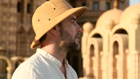 a tourist stands with a camera near the mosque,minaret.archeology