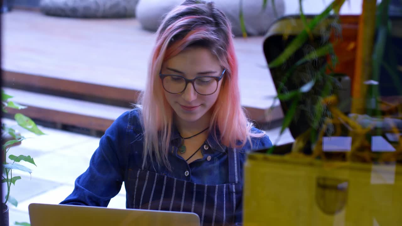 propietaria femenina trabajando en una computadora portátil 4k