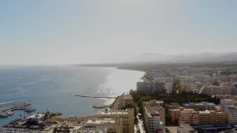 drone shot panning from the sea and the marina to marbella town