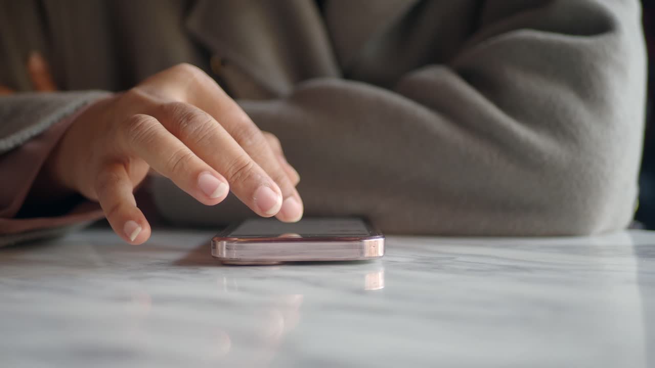 드폰 화면을 만지는 여성의 손의 클로즈업.