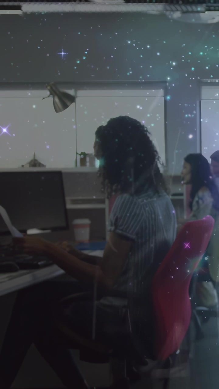 Vertical video: Woman at office glancing paper picking it up and checking while sparkles mark text