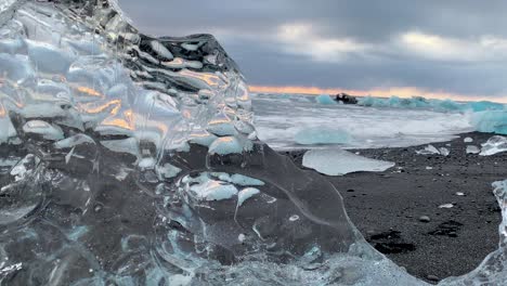 Clear-Iceberg-On-Diamond-Beach-During-Sunrise-In-South-Iceland