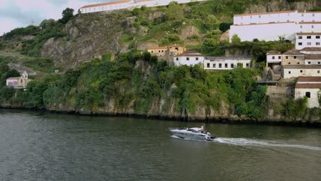 a yacht cruising by in the river in porto, portugal