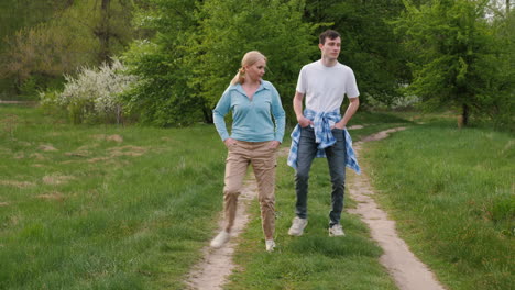 madre y hijo caminando en un parque de primavera