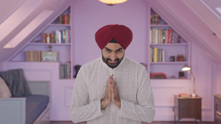 Happy Sikh Indian man doing Namaste