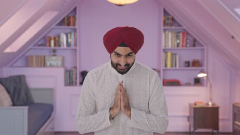 happy sikh indian man doing namaste