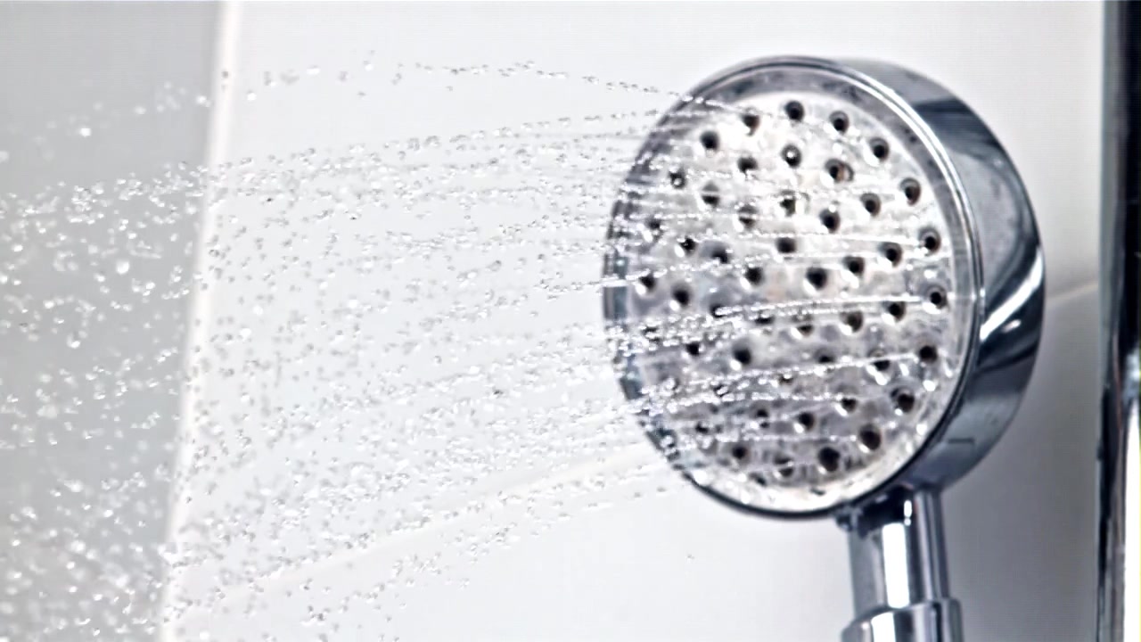 Close-up of a Chrome Shower Head Spraying Water