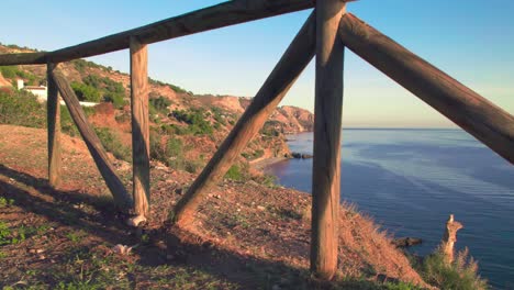 Moviéndose-Lentamente-A-Través-De-Una-Valla-De-Madera-Para-Revelar-La-Costa-De-Nerja,-Andalucía,-España