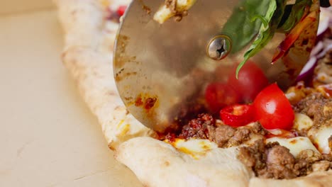 cutting a pizza from the top close up view