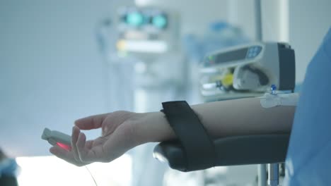 patient receiving iv treatment with pulse oximeter monitoring