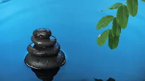 pyramid, leaf and droplet falling in blue water.