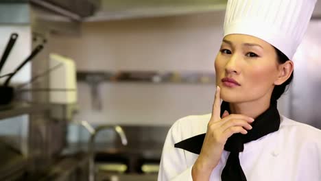 thoughtful chef smiling at camera