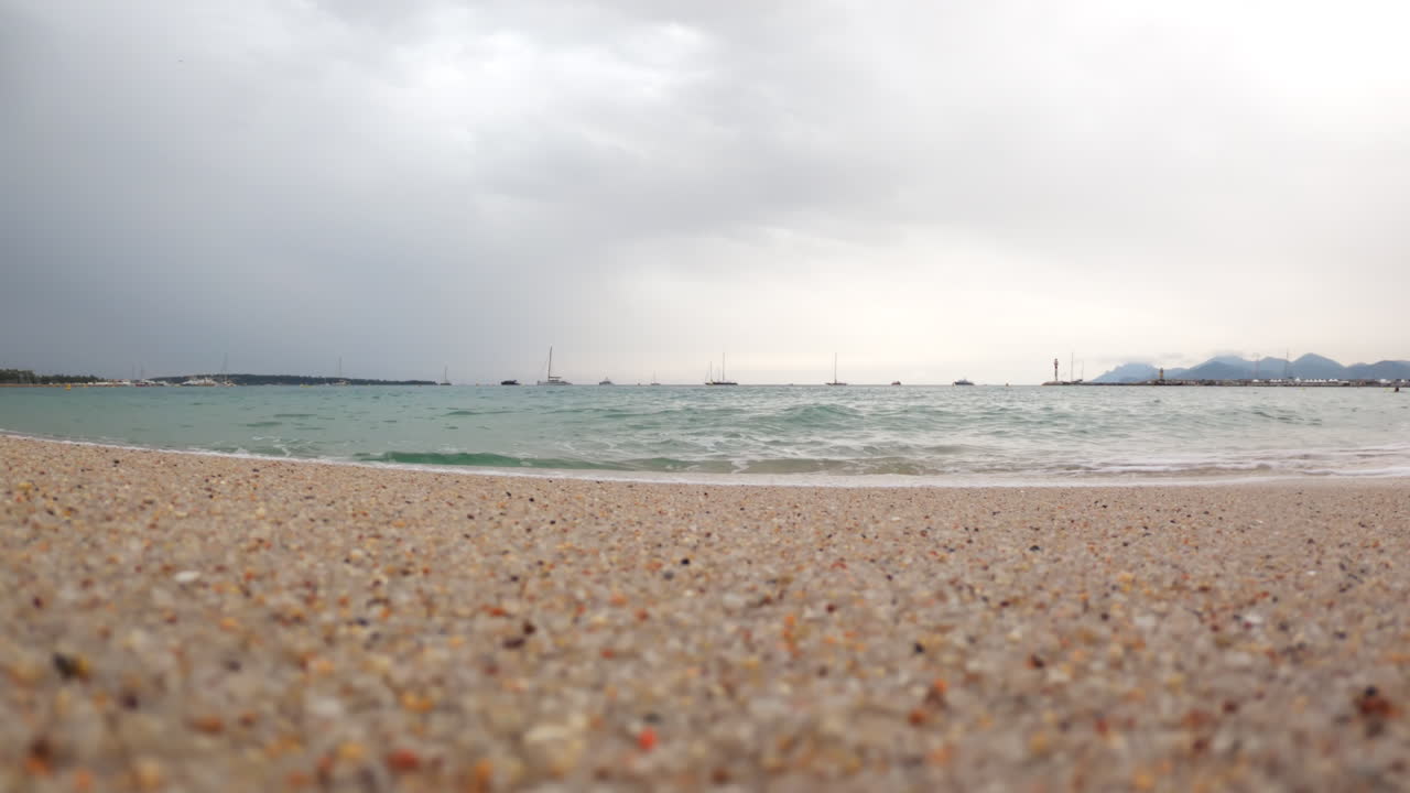 Woman running on the beach with waves hitting the shore