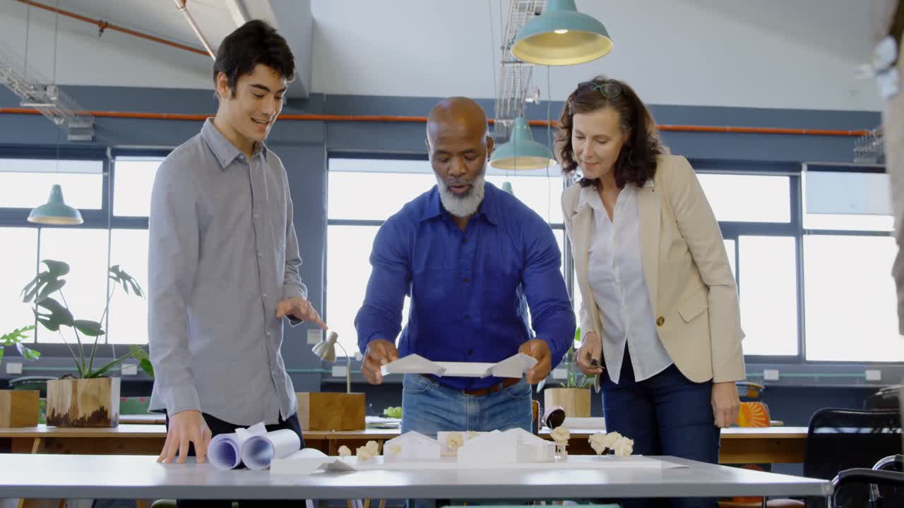 Executive working on architectural model at table 4k